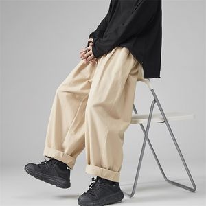 Herrbyxor avslappnad wied ben överdimensionerad bomullsbyxor solid färg mode män jogga koreanska streetwear vintage 5xl 220826