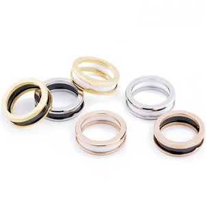 Anello stile Europa America Uomo Donna Donna Inserti con lettera incisa in acciaio inossidabile Nero Bianco Ceramica Amanti dell'oro 18 carati Anelli stretti Taglia US5-US11