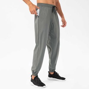 Leggings de ginástica calça esportiva solta masculino zíper de bolso de bolso de bolso de secagem rápida calça de secagem