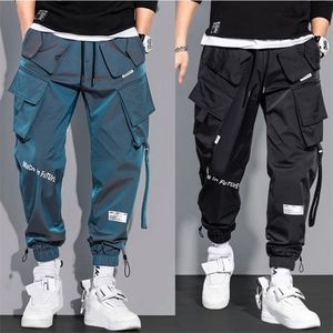 Męskie spodnie ładunkowe moda Hip Hop Multi-Papośle Spodnie Trendy Streetwear Solid Stupants Pantelones Casuales Para Hombre 220721