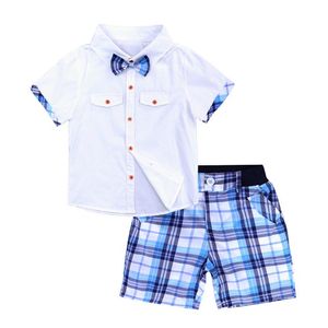 Set di abbigliamento per bambini Abiti estivi Set di abbigliamento per ragazzo per bambino Camicia con papillon bianco Pantaloncini a griglia Pantaloni Set di vestiti per ragazzo