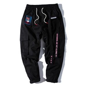 Homens corredores hip hop harem streetwear fitas carta bordado calças casuais populares calças de carga rosa