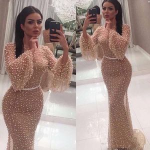 Nuovi abiti da sera sexy Dubai Arabic Mermaid Long Maniche indossano Pearls Champagne Jewel Neer Sheer Back Abito da ballo formale Abito da festa