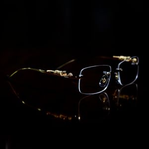 halbrandlose brillen großhandel-Luxusdesigner Sonnenbrille Brillenrahmen Tempel mit Panther Köpfe Metallrahmenloser Felge Semi Randlose rechteckige Form für Männer Frau Brillen Zubehör