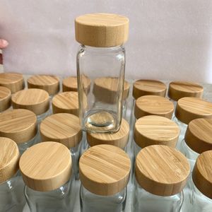 Frascos de almacenamiento de especias herméticos de vidrio pequeños cuadrados de 4 oz y 120 ml, botellas de embalaje con tapas de madera de bambú, enviadas por ocean express/rail/camión