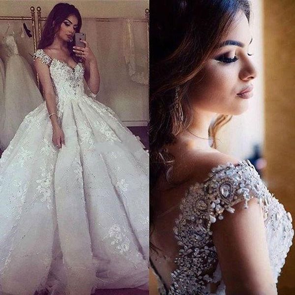 

Luxury Bling Sequined Lace Wedding Dresses Arabic Dubai Ball Gowns Bridal Gowns Cap Sleeves Beaded Crystals V Neck Puffy Long Gowns Custom