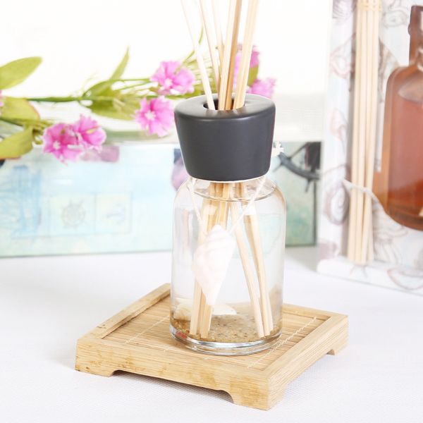 

100ml ocean series aroma diffuser with black and white ceramic cap and clear glass sand and shell inside ocean coastal sunflower