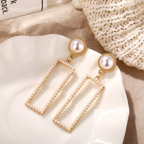 

pearl earrings with geometric trim and elegant earrings, White