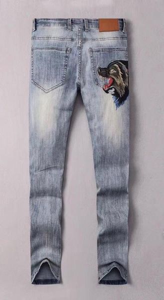 

2020 famous casual brand designers design slim fashionable blue ripped wolf embroidery jeans motorcycle trousers pencil pants men and woman