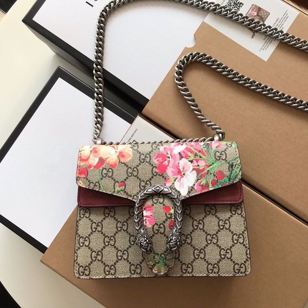 

classic ladies cross body bag: a structured mini bag made of artificial leather with woven tiger spurs and a sliding chain bag