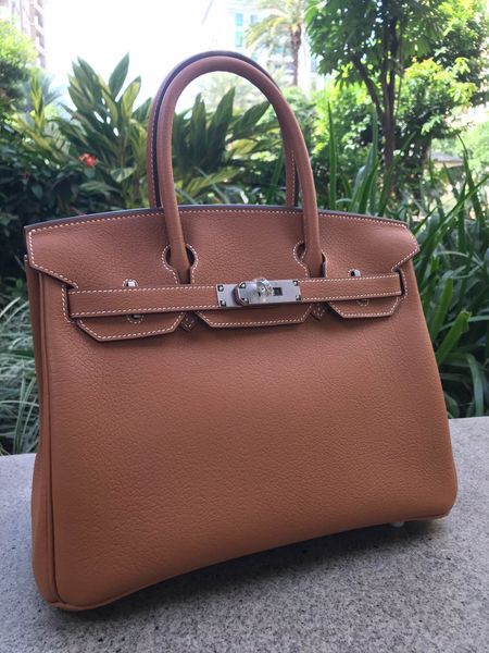 

whosale fully handmade 30cm togo leather design purse,browncolor,wax thread, have both gold and silver hardware,contact me for details