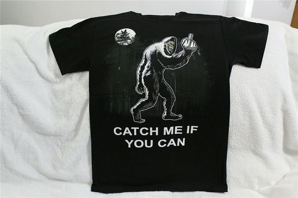 

bigfoot catch me if you can flip off middle finger sasquatch funny t-shirt loose fit tee shirt