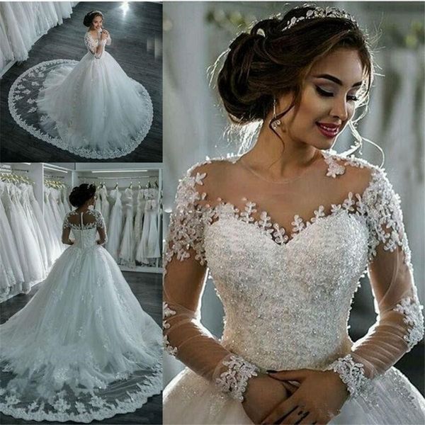 

Sexy See Through Long Sleeve Wedding Dresses Ivory Sheer Bling Beaded Lace Applique Jewel Neck Ball Gowns Chapel Bridal Gowns