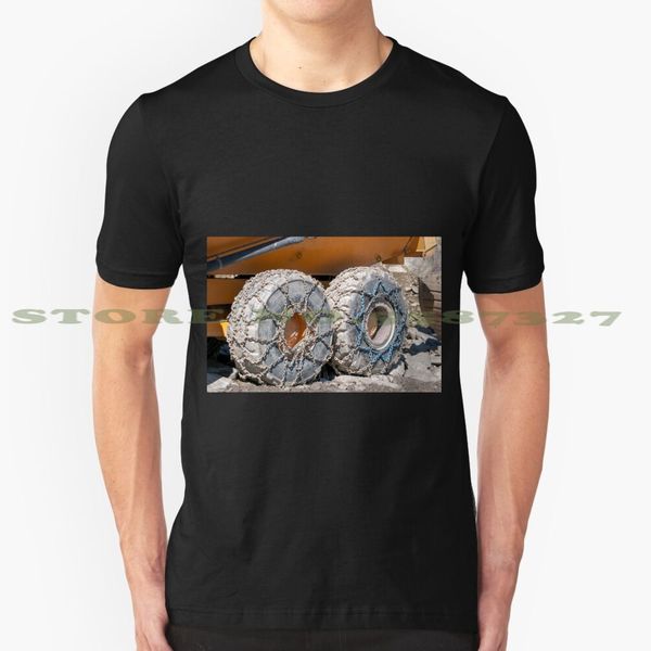 

heavy earth moving equipment with snow chains on its tyres. pgraphed at stubaier wildspitze tyrol , austria black tshirt