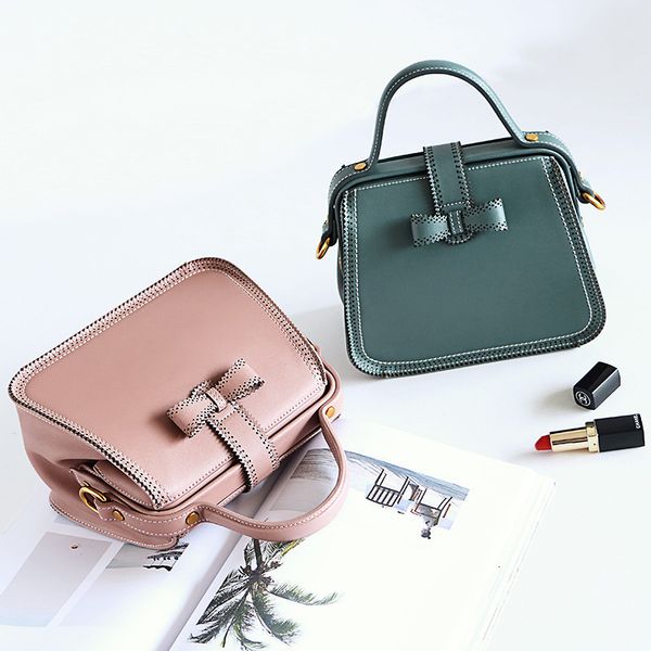 

2020 a new double faced female hand clutch bag women's fashion lock color bag bow tie cowhide 's wild shoulder korean
