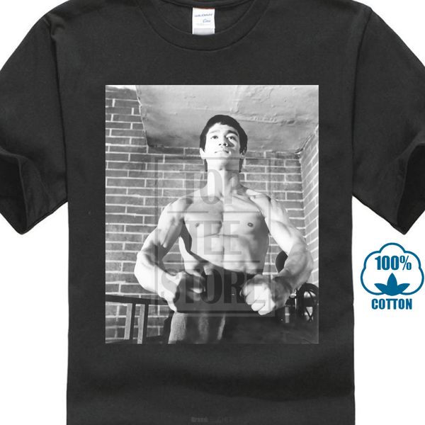 

bruce lee mens t shirt bruce power pose in front of brick wall image 018773
