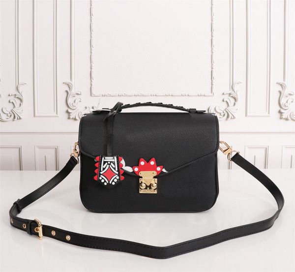 

crafty pochette mÃ©tis embossed leather extra-large print letters braided handle graffiti inspired charm shoulder messenger bag 2020