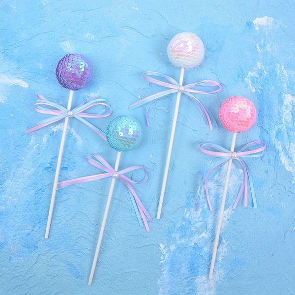 

large round sequin ball cake decorated with bow and lollipopchildren's year old lollipop accessories baking accessoriesdecorative bakin