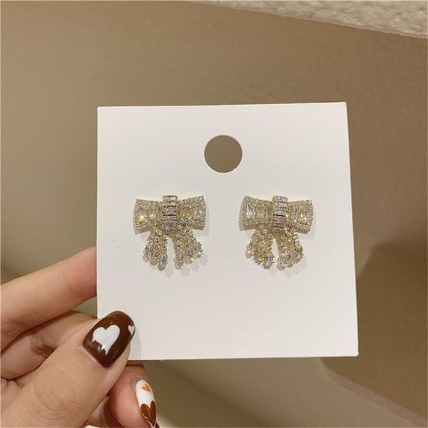 

aomu 2021 new fashion rhinestone hollow geometric bowknot small stud earrings for women cute new year jewelry, Silver
