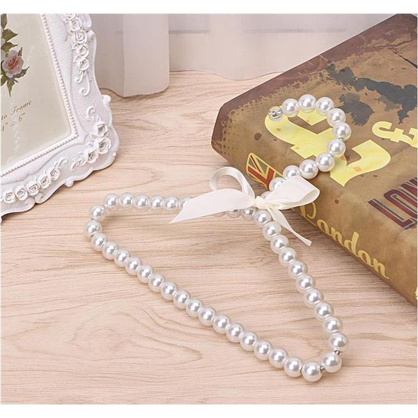

wholesale 10 pcs fashion plastic pearl beaded bow baby clothes hangers storage dry rack shipping