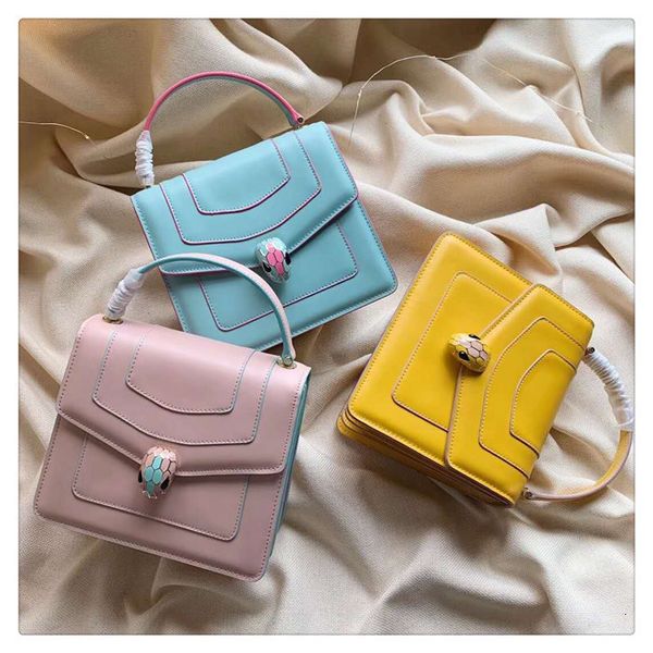 

sweet lady candy snake head bag with copper chain straddling one shoulder