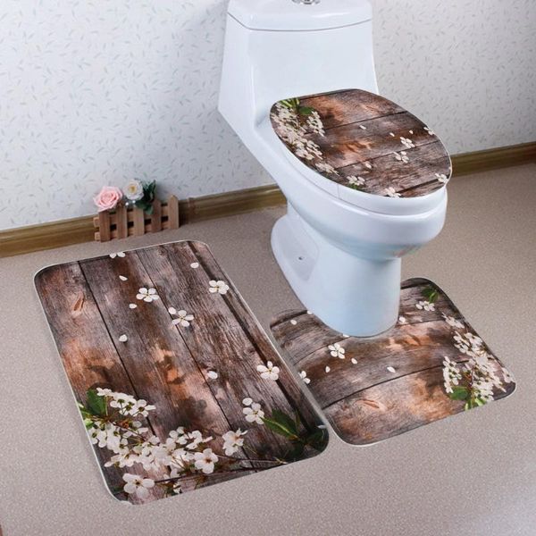 

three-piece toilet mat in front of bathroom door