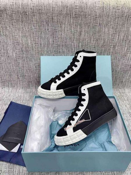 

rubber platform inspired by motocross tires defines the unusual design of these nylon gabardine sneakers. the logo triangle decorate, Black;red