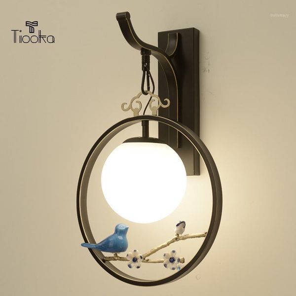 

tiooka chinese style indoor tv background wall sconces light black gold round bedside wall hanging lamp with vivid bird decor1