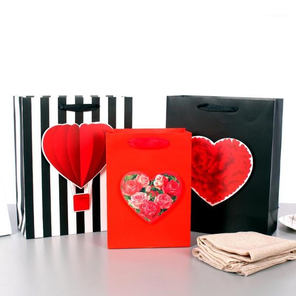 

gift wrap happy valentine's day paper bags with big heart/ balloon tip-ons holding gifts to show care & love1
