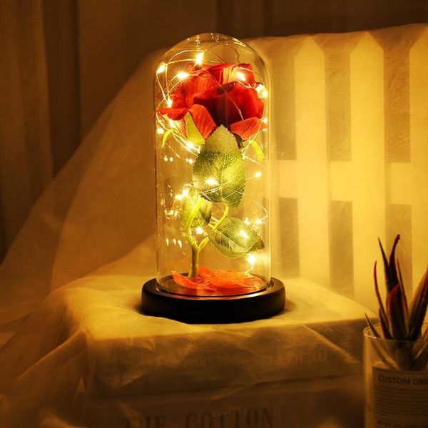 

artificial eternal red silk rose with fallen petals in glass dome on a gift for valentine's day glass cover home decor