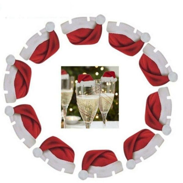 

10 champagne glasses with christmas ornament hats to add a festive atmosphere to the table place glass decoration