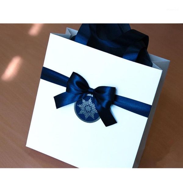 

christmas gift bags for guests with navy blue satin ribbon, bow and snowflake tag elegant welcome paper bags - holiday gift bag1