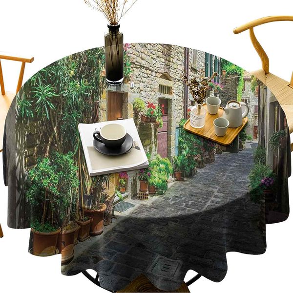 

waterproof round table cover doorway to tuscan house build with cobblestone with many flowering plants