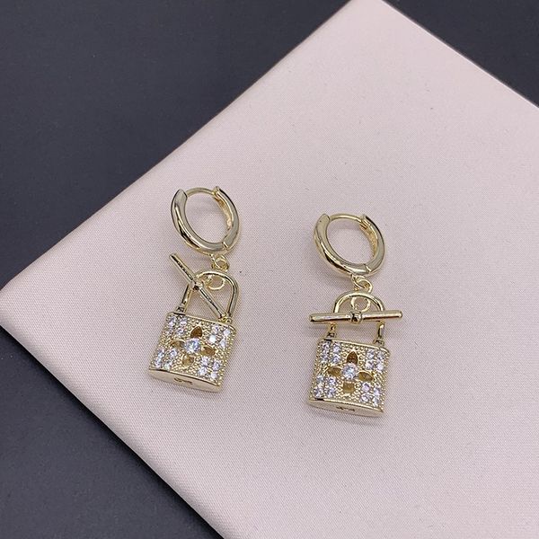 

european and american small gold lock earrings full of diamond hollow four leaf flower buckle ins, Silver