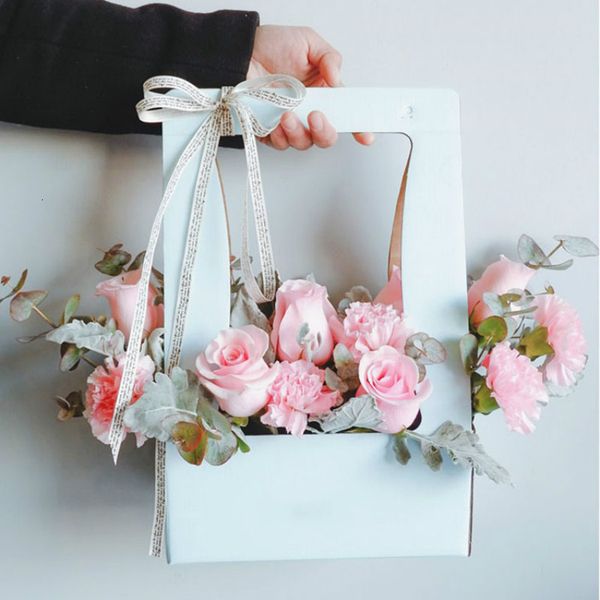 

flower hand vintage held wrapping basket box gift flowers bunch packaging paper