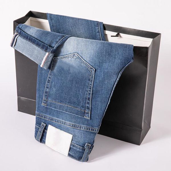 Jeans estivi da uomo all'ingrosso Streetwear Pantaloni skinny in denim elasticizzato con fori azzurri strappati taglia 38