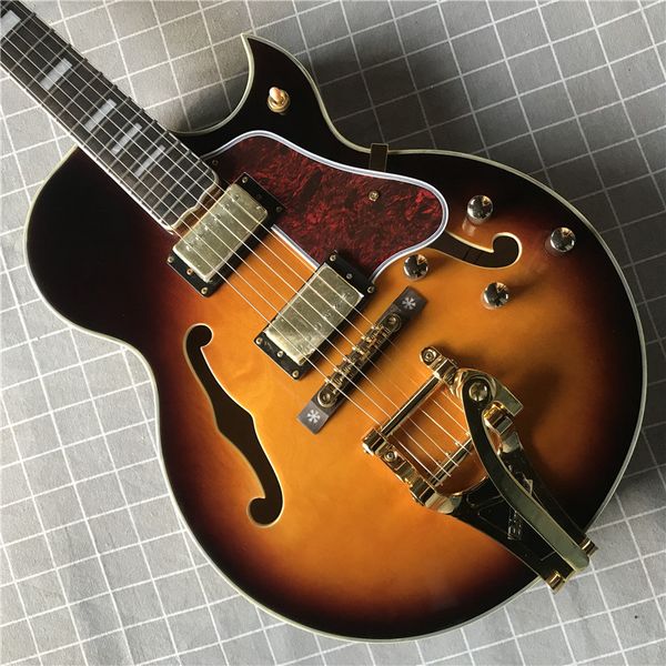 

jazz electric guitar, yellow, hollow body, gold hardware, hot