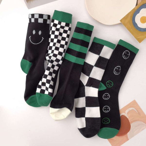

green trendy female smiling face black white checkered striped couple