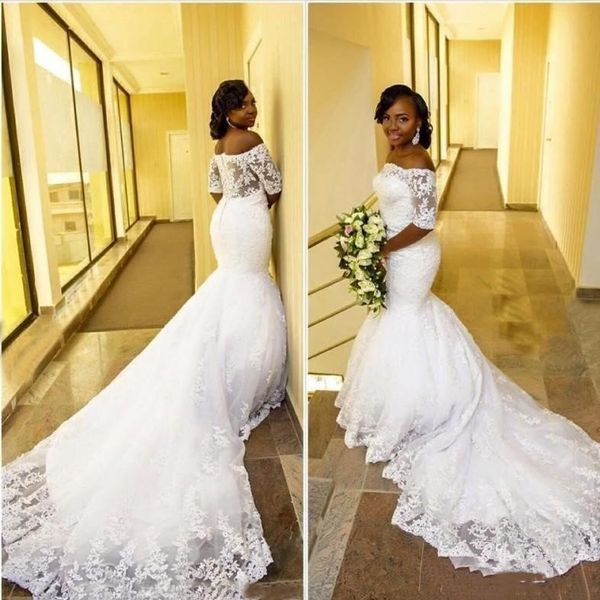 

2021 african mermaid wedding dresses with 1/2 half sleeves lace applique sweep train off the shoulder covered buttons back wedding gown, White