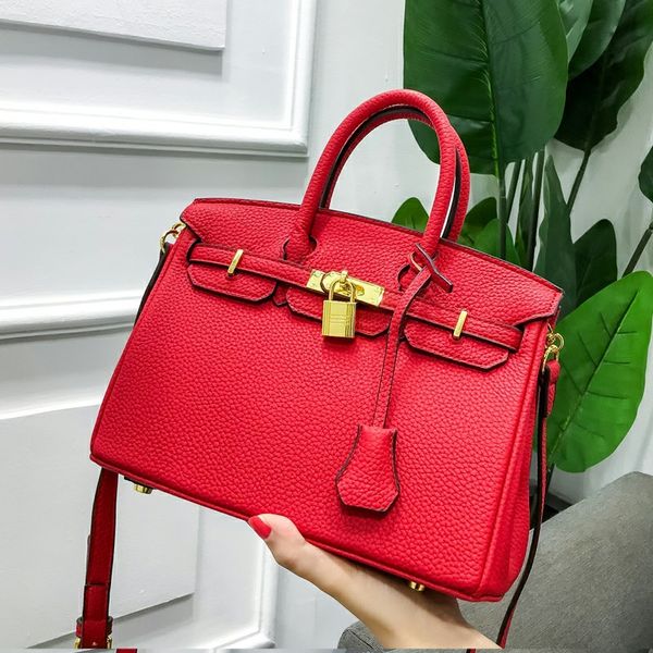 

spring and summer new head litchi pattern lock leather hand women's bag