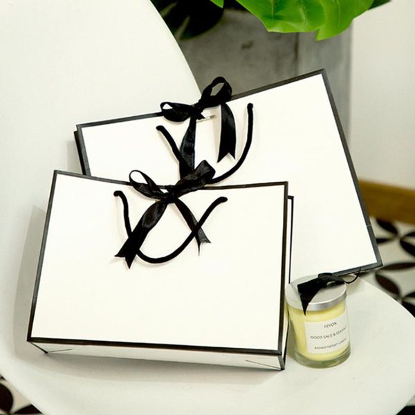 

gift wrap wholesale 500pcs/lot white luxury printed custom shopping paper bags with your own logo and bowknot