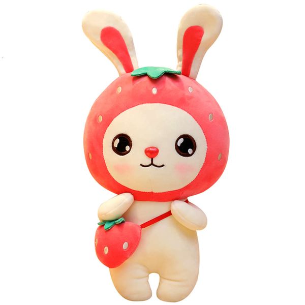 

rabbit plush toy pillow with sping strawberry doll on the bed
