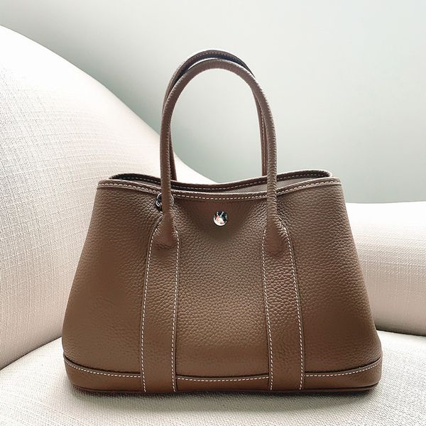 

design hand 2020 new leather litchi pattern garden simple large capacity one shoulder slant cross portable mamitote bag