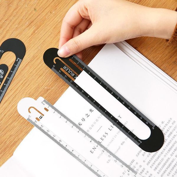 

bookmark hollowed steel ruler hand account paper clip stationery school supplies drawing