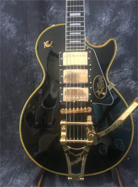 

custom electric guitar shop, solid mahogany body, black paint and yellow binding, gold hardware, 3 pieces guitars guitarra