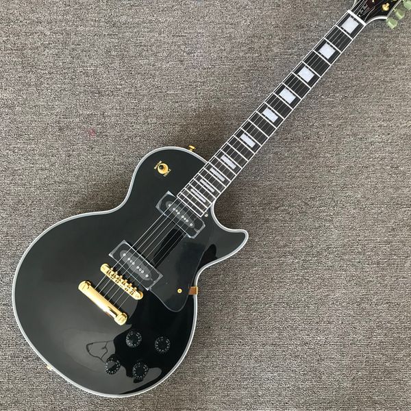 

black electric guitar, rosewood fingerboard, gold hardware, p90 pickups, solid mahogany body electric guitar