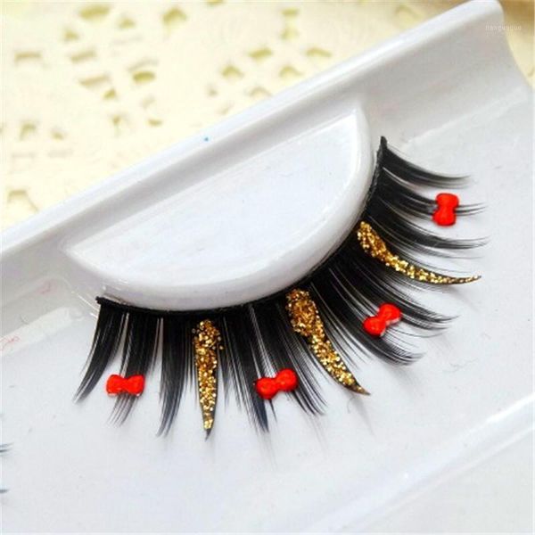 

exaggerated shimmery false eyelashes bow gold glitter latin dance performance party po bride makeup1