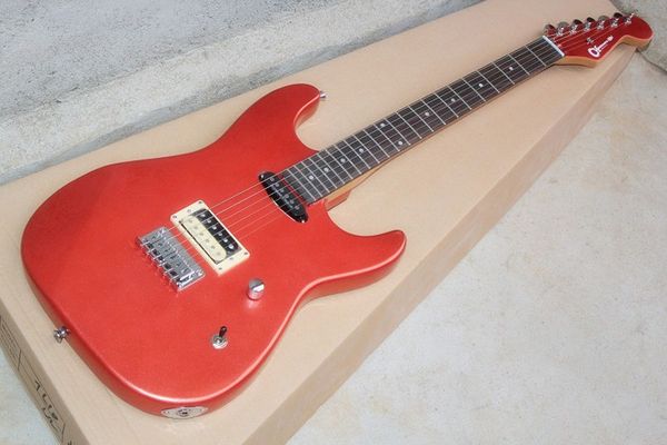 

electric guitar metal red body fixed bridge strings behind rose wood fingerboard