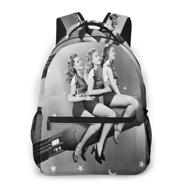 

backpack mountaineering three women sitting on rocket shoulder bags backpacks