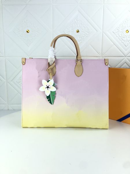 

m57640 m57641 m57639 onthego gm tote bags accessorized with a colorful leather flower charm by the pool bag womens handle shoulder straps